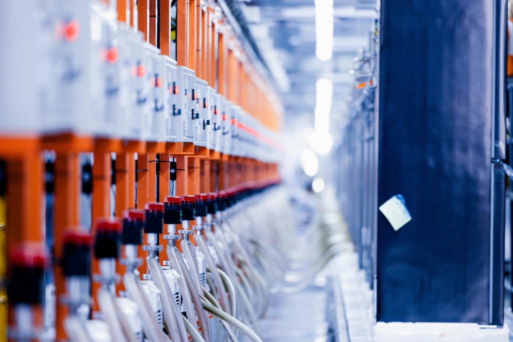 Reihe orangefarbener Schaltschränke mit LED-Anzeigen in einem Rechenzentrum 